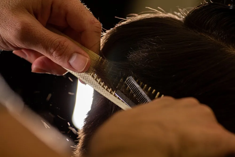 Close-up of a professional comb and shears on the styling station