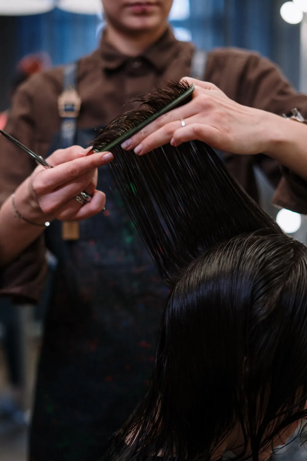 A stylist giving a precision cut on freshly washed hair